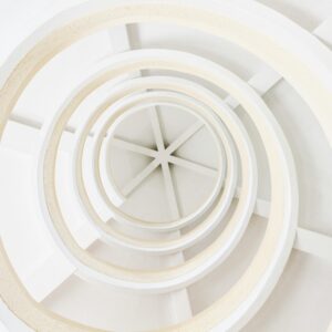Explore this abstract spiral architecture with a modern minimalist design, featuring geometric white patterns.