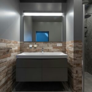 Contemporary bathroom with a glass shower and illuminated mirror.